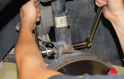 REMOVING THE ORIGINAL FRONT STRUTS Step 11: Support the front suspension underneath the control arm with a floor jack.