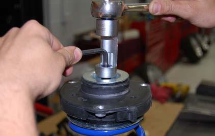 Make sure the arrows on the upper strut mount stay properly positioned as you tighten the shock nut.