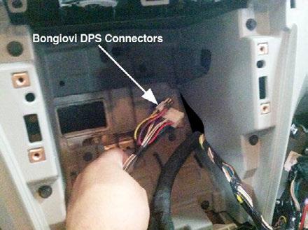 With the radio head unit pulled out of the way, drop the white connectors of the DPS harness though the opening behind radio cavity on the right side (Figure 4).