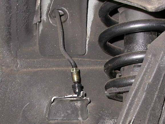 Loosen the hard line fitting from the stock brake line, using a 10mm flare wrench. Remove the brake line retaining clip, using a pair of needle-nose pliers or a screwdriver.