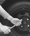 If you have a wheel cover, remove it using the flat end of the jack handle.
