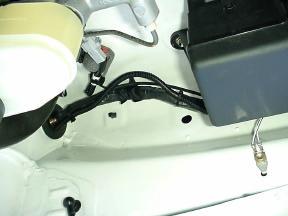 DO NOT OVER TIGHTEN. Route the mirror wire harness into the groove of the windshield wire cover.
