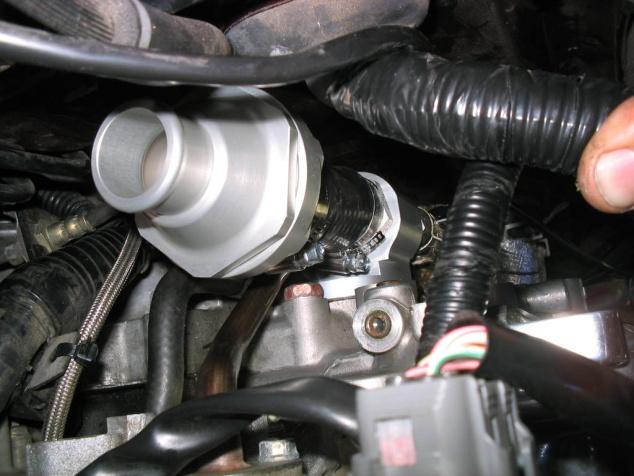 (See Below) Now install the Thermostat housing in the other end of the hose.