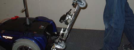Lift front of the wheelchair base and use this as a handle to