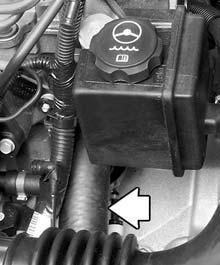 4. With the coolant surge tank pressure cap off, start the engine and let it run until you can feel the upper radiator hose getting hot. Watch out for the engine cooling fan. 5.