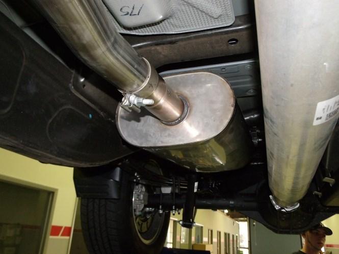 Place a clamp on the inlet of the Muffler Assembly and insert into the Front Pipe Assembly and insert hangar into rubber isolators. Use a muffler stand or an assistant to hold into position. (See Fig.