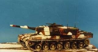 First, the tank was airbrushed in NATO three-tone with Tamiya paints (XF-1 flat black, XF-64 red brown, and XF-58 olive green), and then a white wash added over the green camouflage color with