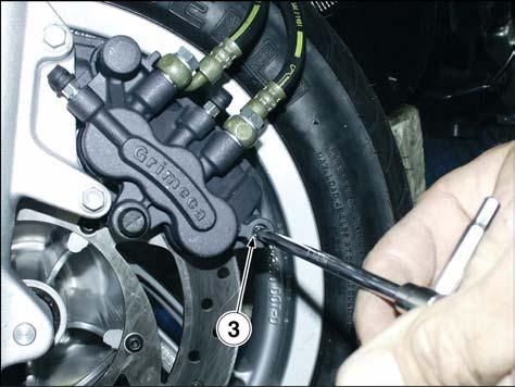 Push the brake calliper pistons fully open, tilt the calliper outwards and ease it off the brake disc.