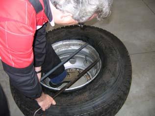 Hold one tyre lever in position with your foot and remove the second lever, then