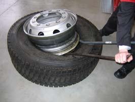 Alternative Lift the tyre and wheel assembly carefully and turn it over then carefully lower