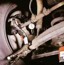 Turn the lever to tighten the indicator in place. Typical mounting of a dial indicator for an axial check.