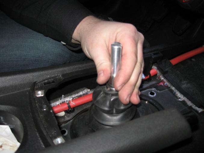 Then insert the shifter shaft, having a friend in the car to guide the shaft thru the upper