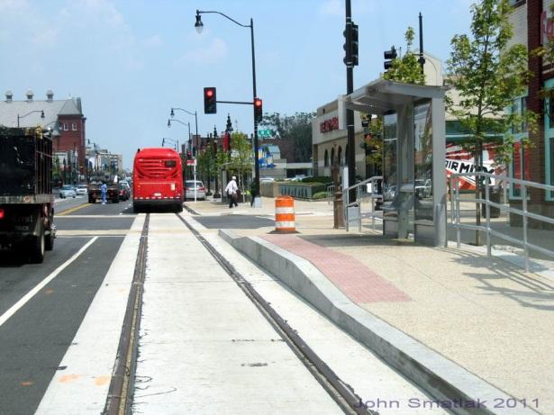 Right: Track in center lane, streetcar and bus stop separated but adjacent.