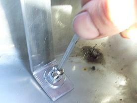 Place the flat washer, then spring washer onto the base of the enclosure over each hole,