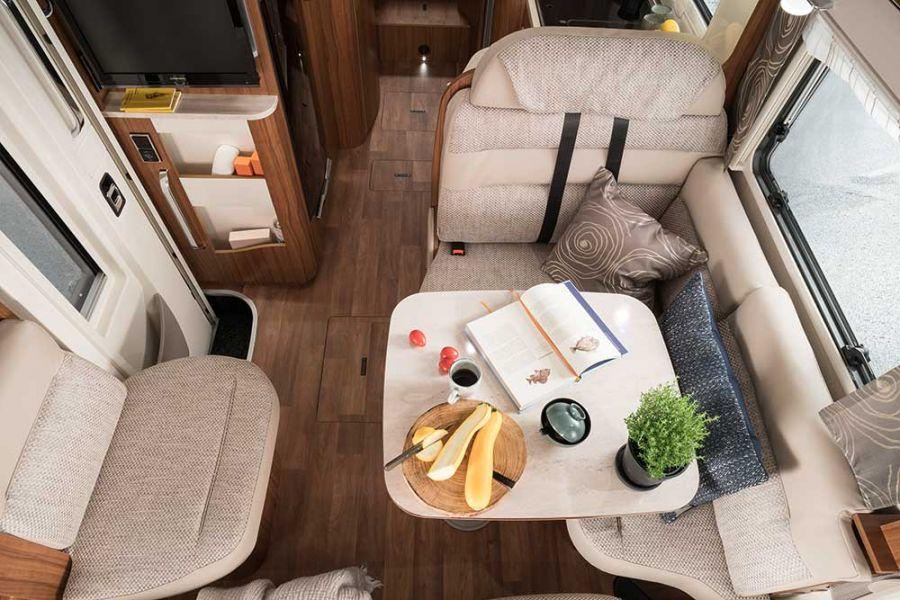 Hymermobil B-Class DynamicLine Living room The comfort L-shaped seating area with lounge upholstery shown here in the furniture finish Palatino Apple Cream together with the optional