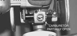 Rotate the arm on the carburetor to fully close the carburetor.