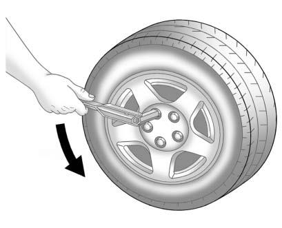 Use the wheel wrench to loosen all the wheel nuts. Turn the wheel wrench counterclockwise to loosen the wheel nuts. Do not remove the wheel nuts yet.