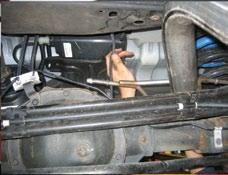 6) Remove the tailpipe section from the vehicle by lifting the tailpipe over the rear axle and backwards under the rear bumper.