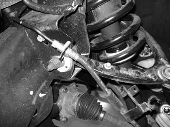 To avoid having to bleed the brakes, cut an opening in the factory brake line bracket so the bracket can be removed from the line. Take care not to nick the brake line.