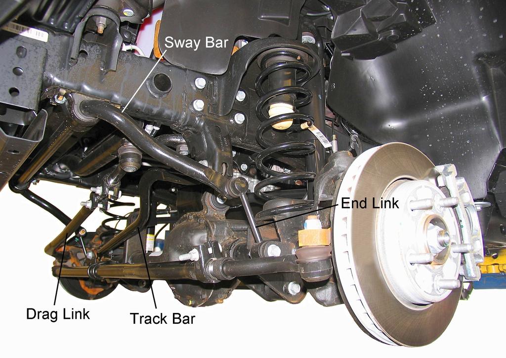 OE Front Suspension 6) Support the front axle with a jack. Remove the shock absorber upper nut, retainer, and bushing.