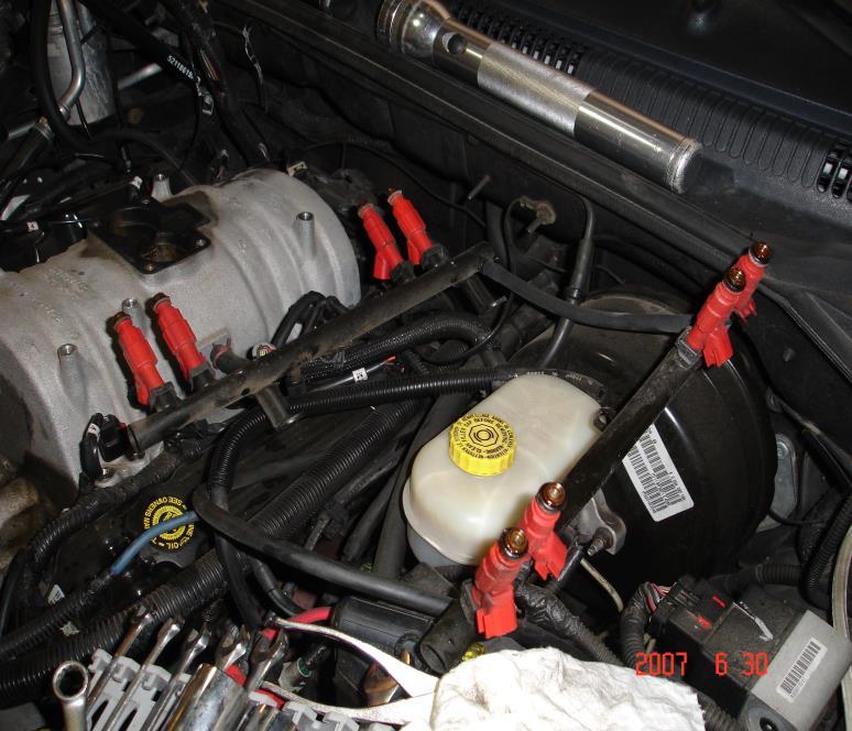 3. Drain the coolant and disconnect all hoses and wiring harness