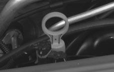 Then, without shutting off the engine, follow these steps: The automatic transaxle fluid dipstick handle is the red loop located toward the rear of the engine.