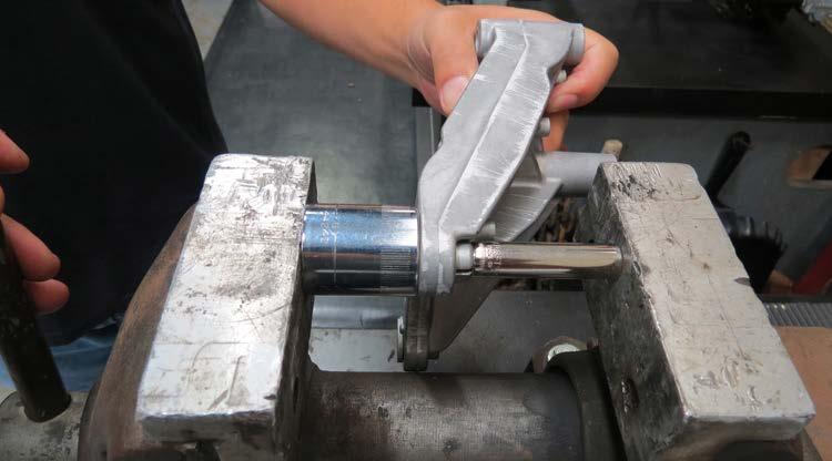Using a vise, a 1/2 24mm socket and a 3/8 9mm deep socket, carefully remove two bushings from the factory