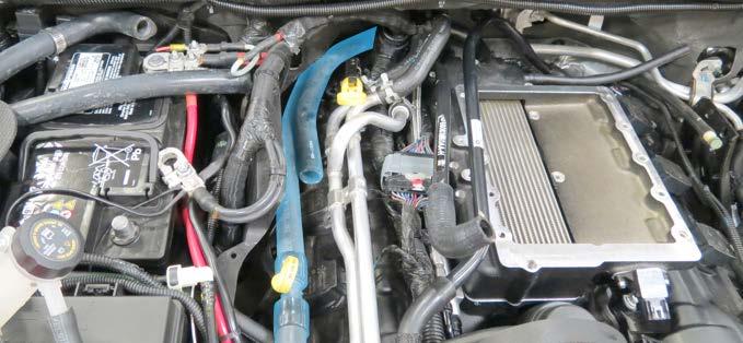 73. Carefully route the hoses around the engine harness and position the upper manifold onto the lower manifold. 77.