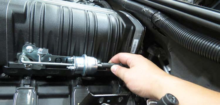 Carefully lower the supercharger onto the upper manifold and verify that the gasket is properly
