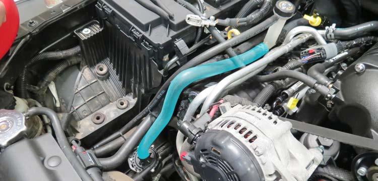 Using a hose clamp from bag #2, secure the straight end of the Water Pump to LTR hose