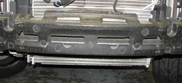 Remove the five push-pins and three screws that secure each of the front inner fender wells.