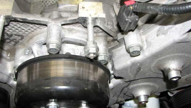 Remove the alternator mounting stud on the driver s side of the engine using a 5.