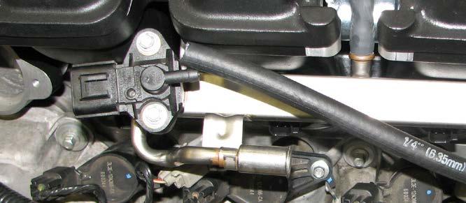 Align each of the fuel injectors with its prospective well, then pull the top of the rail outboard so