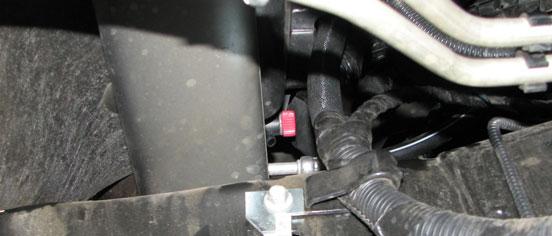 Use a pair of pliers or a clamp removal tool to remove the upper radiator hose. 31.