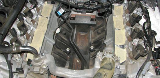 Place a tray below the passenger side frame rail to collect coolant as it drains, then loosen the petcock at the bottom of the radiator to drain