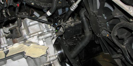 Position a drain pan below the radiator then disconnect the lower radiator hose from the engine. 62.