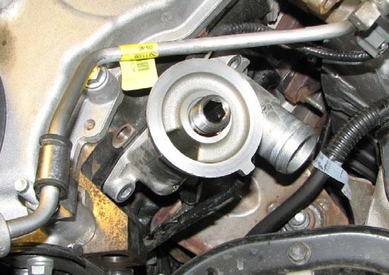 Use a 12mm wrench to remove the front cover bolt adjacent to the oil filter bracket. 75.