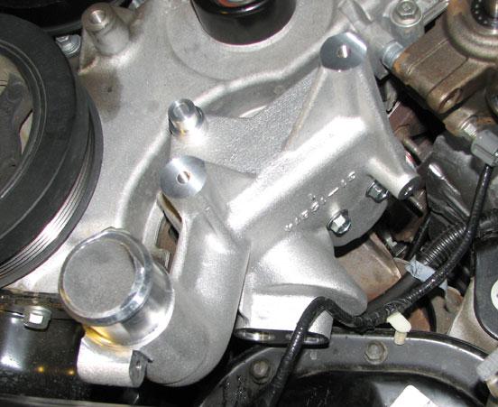 77. Place the oil filter bracket gasket on the flange of the supplied bracket. Once the bracket is close enough, attach the electrical connector to the oil pressure sensor. 81.