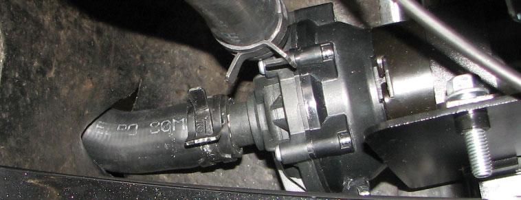 Identify the mounting holes on the water pump bracket then hold the bracket in place behind the bumper, on the passenger side, to identify the inner frame horn nut and bumper beam bolt that will need