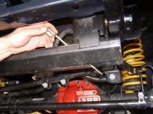 11. Pass caged nut plate from top through crossmember, then upwards into open end of chassis rails. 12.