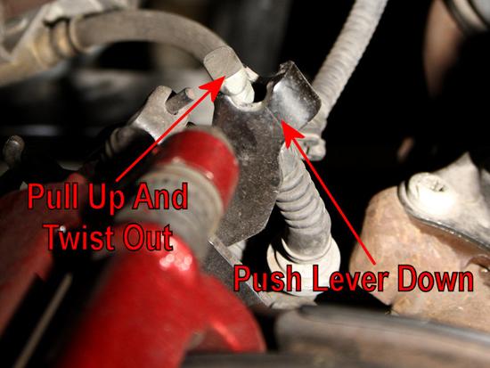 5. Push the lever down, and then twist the cable end slightly to disengage it from the