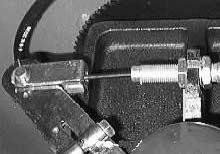 CHASSIS 9. Reinstall the cotter pin and clevis pin in the end of the brake cable where it attaches to the lever on the wheel support. 10. Turn the steering wheel all the way to the right. 11.