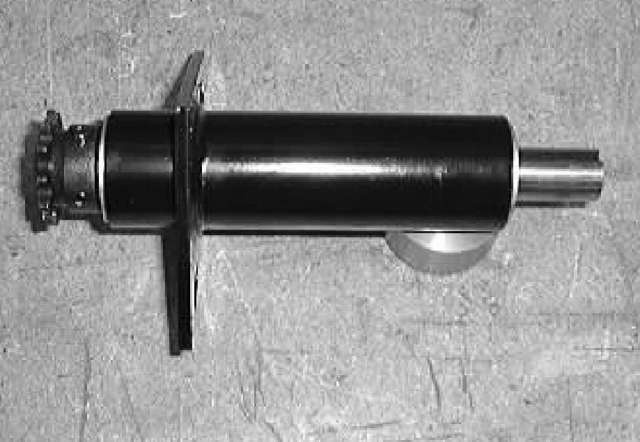 Use an arbor press to press the short steering shaft and two bearings out of the housing. Discard the bearings.