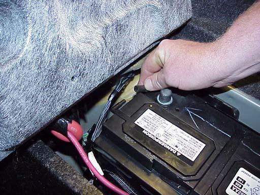 If the vehicle is equipped with a police package, continue with Step 3 of this procedure. a. Disconnect the battery positive cable clamp from the battery terminal (Figure 2). b. Unlatch the battery retention strap.