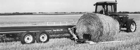 Once the bale is against the fork arm, raise the fork fully to the upright position, allowing the bale to roll