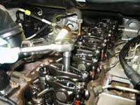 8: Remove 10mm bolts holding exhaust rocker arms,