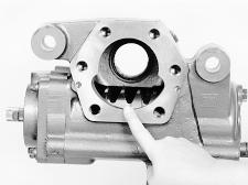 There are four teeth on the rack piston. Rotate input shaft to position the rack piston so the space between the second and third tooth is in the center of the sector shaft opening.