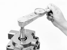 When using a torque in locknut tool J37464, the torque reading should be 112 lbf ft (152 N m). The bearing adjuster, locknut and valve housing flange should be flush.