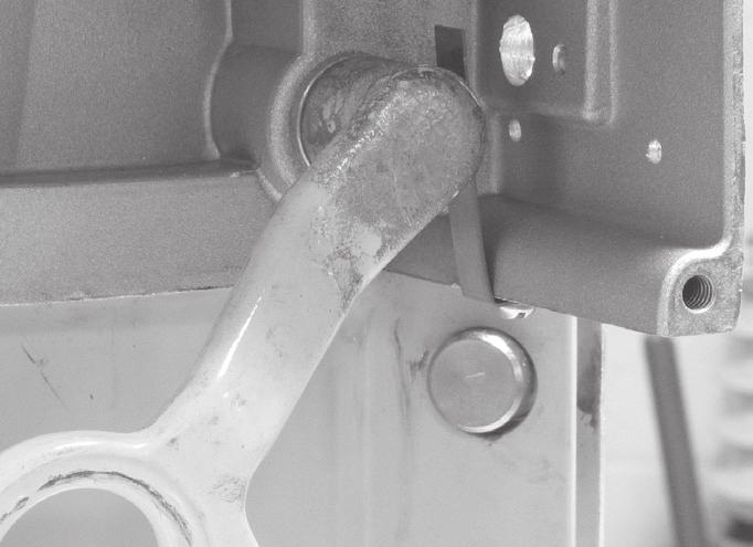 From the backside of the recloser operating lever, center the smaller diameter face of the locating cone within the recloser handle ring and firmly secure it using the knurled shoulder bolt and