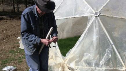 After you cover the dome with greenhouse plastic, cut the plastic along two sides of one of the triangles.